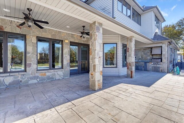 view of patio / terrace featuring ceiling fan, a grill, and exterior kitchen