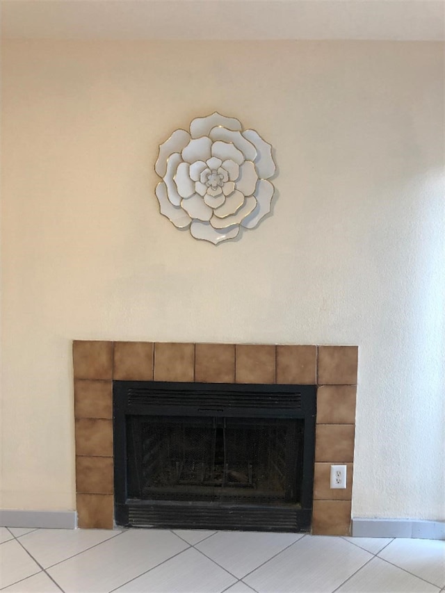 interior details with tile patterned floors and a fireplace