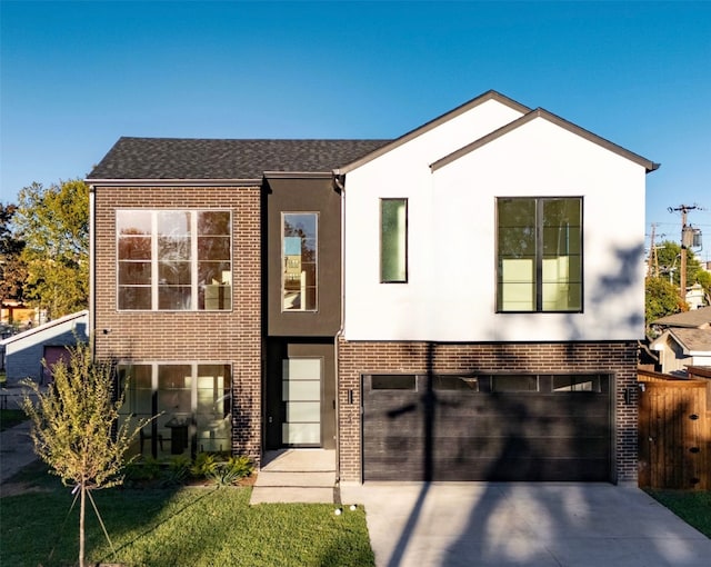 view of front of home with a front lawn and a garage