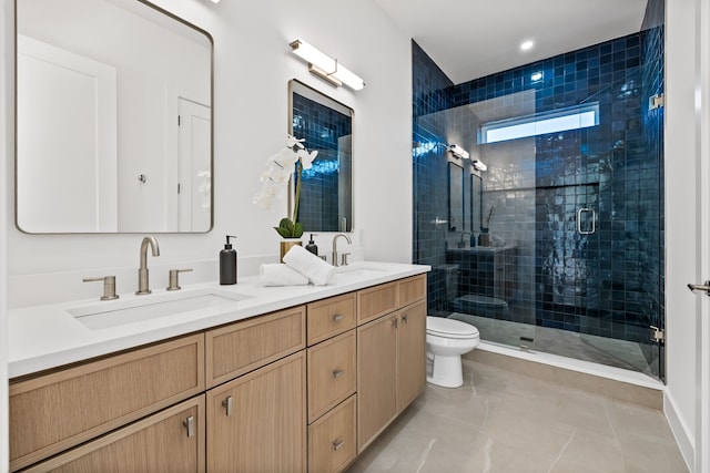 bathroom with tile patterned flooring, vanity, toilet, and a shower with shower door