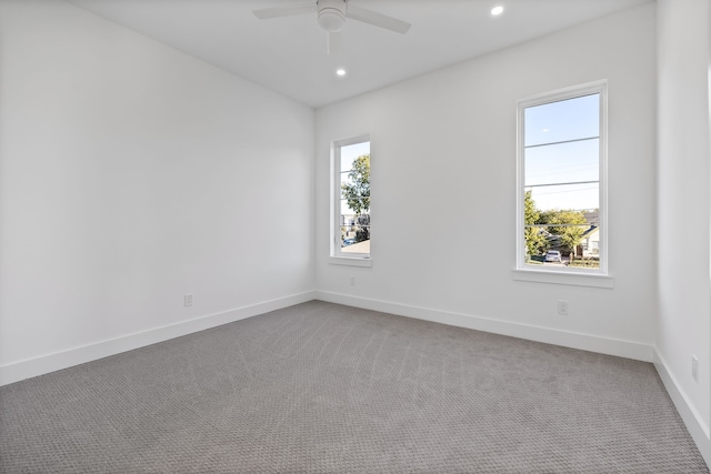 unfurnished room featuring ceiling fan and carpet floors