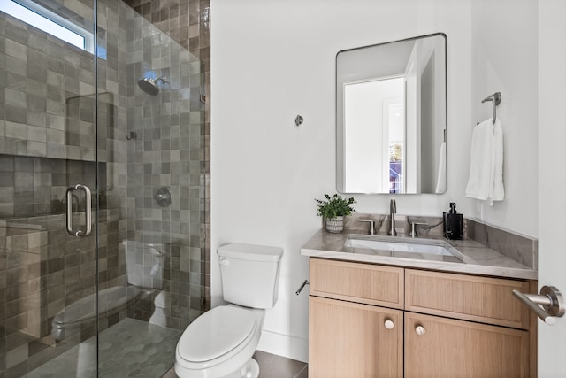 bathroom featuring vanity, toilet, and walk in shower