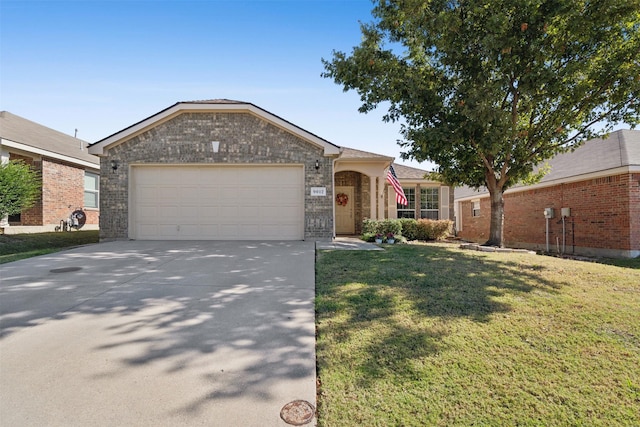 ranch-style house featuring a front yard and a garage