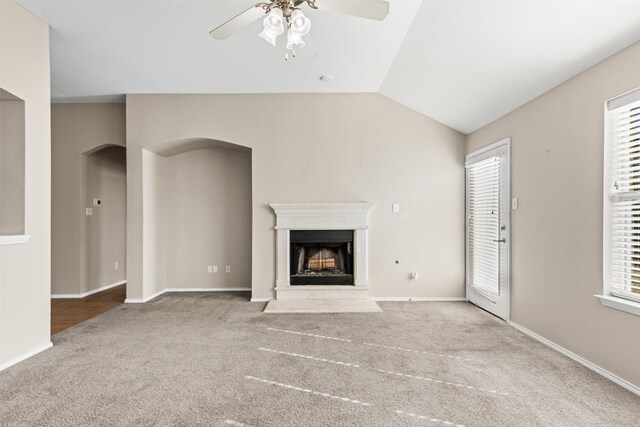 kitchen featuring a center island, backsplash, vaulted ceiling, light tile patterned floors, and stainless steel appliances