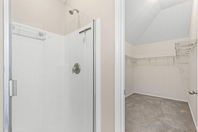 bedroom featuring ceiling fan, light carpet, and vaulted ceiling