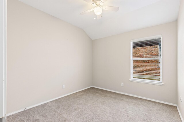 bathroom featuring tile patterned floors, vanity, vaulted ceiling, and a tub