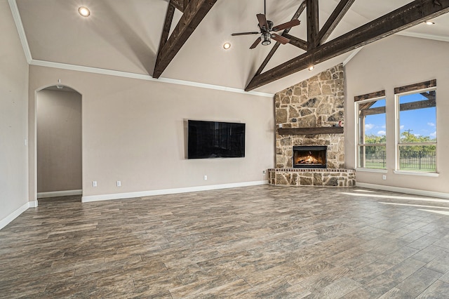 unfurnished living room with beamed ceiling, a stone fireplace, wood-type flooring, and high vaulted ceiling