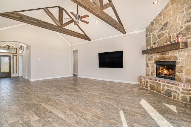 unfurnished living room with beamed ceiling, wood-type flooring, high vaulted ceiling, and a fireplace