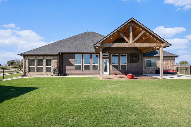 back of property featuring a yard and a patio area