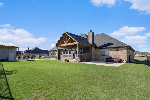 back of property featuring a yard and a patio area