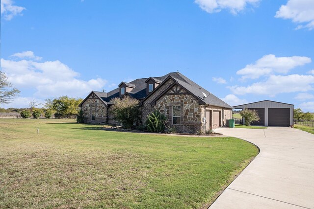 french provincial home with an outdoor structure and a front yard