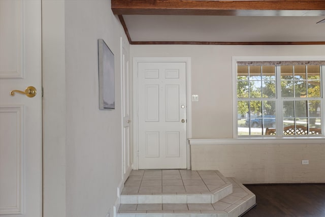 interior space featuring beam ceiling, tile patterned floors, and a wealth of natural light