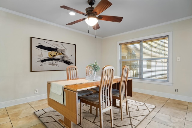 tiled dining space with ceiling fan and crown molding