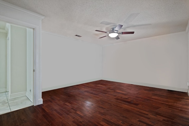 spare room with a textured ceiling and dark hardwood / wood-style floors