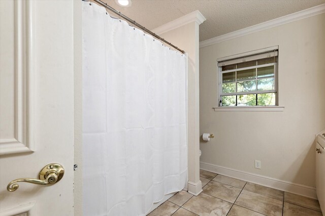 bathroom with crown molding, tile patterned flooring, and a textured ceiling