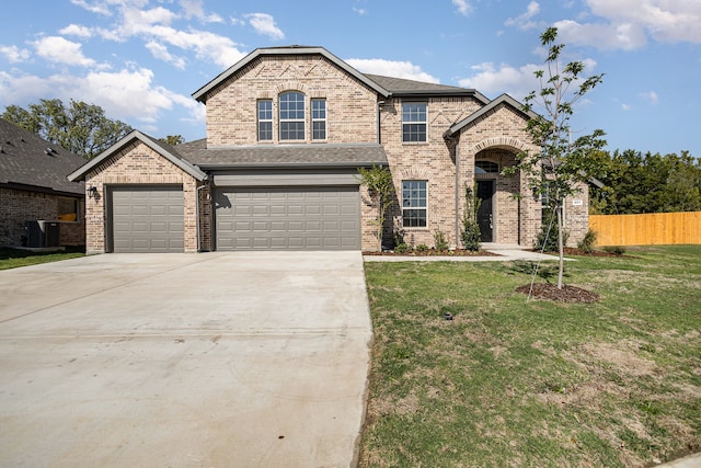 view of front of house with central AC unit, a front yard, and a garage