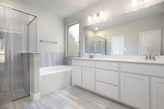 bathroom featuring tile patterned flooring, vanity, and separate shower and tub