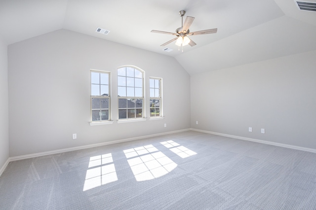 carpeted empty room featuring vaulted ceiling and ceiling fan