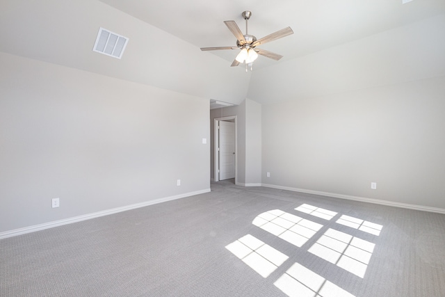 empty room with ceiling fan, light carpet, and vaulted ceiling