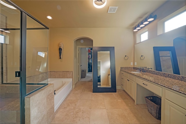 bathroom featuring tile patterned flooring, vanity, and independent shower and bath