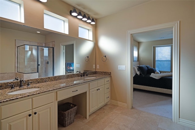 bathroom with vanity, tile patterned floors, and a shower with door