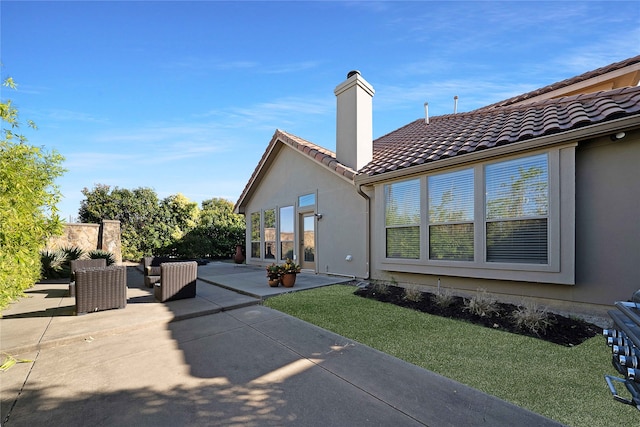 rear view of property featuring a patio area and a yard