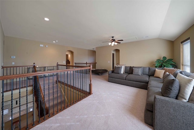 carpeted living room with ceiling fan and lofted ceiling