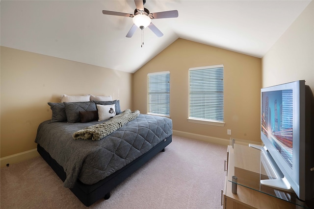 carpeted bedroom with ceiling fan and vaulted ceiling