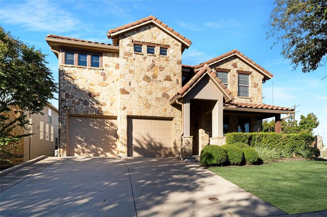 mediterranean / spanish-style house with a garage