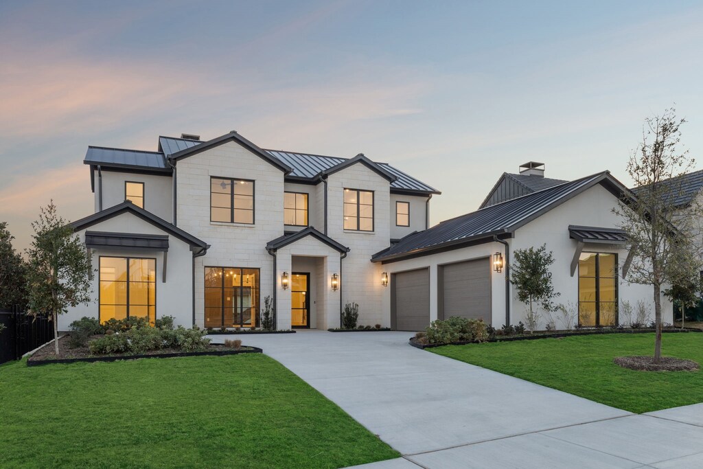 view of front of house with a front yard and a garage