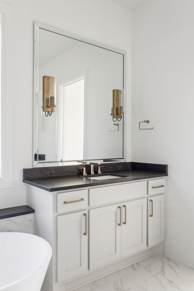 bathroom with marble finish floor and vanity