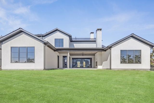 rear view of property featuring metal roof, a standing seam roof, a ceiling fan, and stucco siding