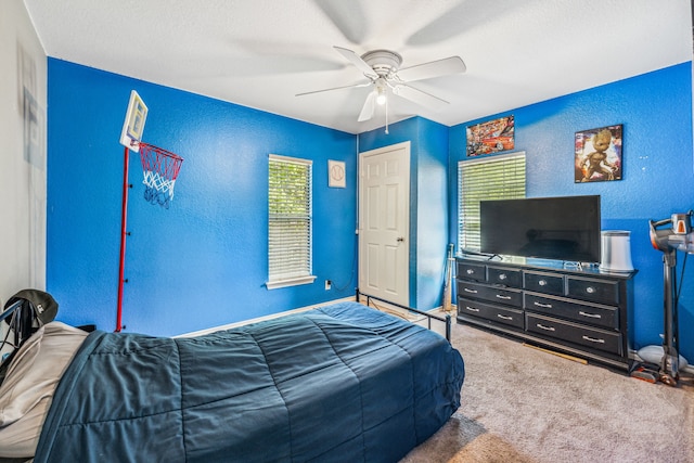 bedroom with ceiling fan and carpet floors