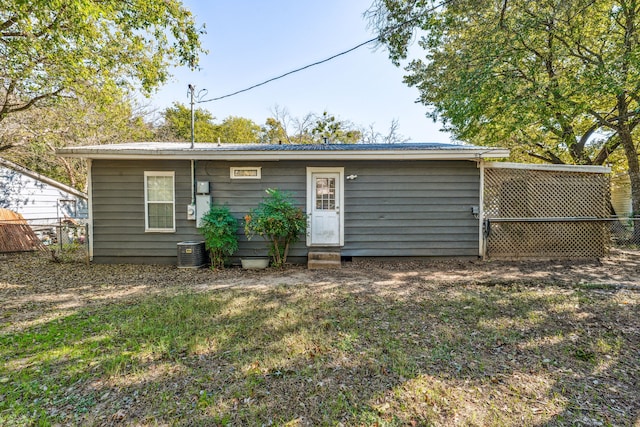 rear view of house with cooling unit