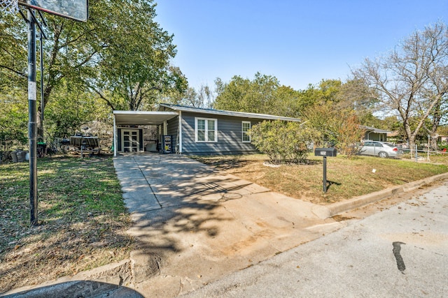 ranch-style home with a front lawn and a carport