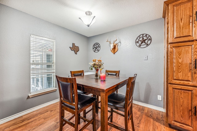 dining space featuring wood-type flooring