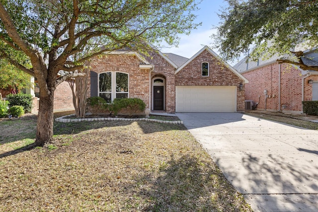 traditional home featuring brick siding, central air condition unit, an attached garage, and concrete driveway