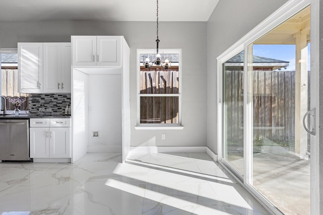 kitchen featuring decorative backsplash, stainless steel dishwasher, marble finish floor, and white cabinetry