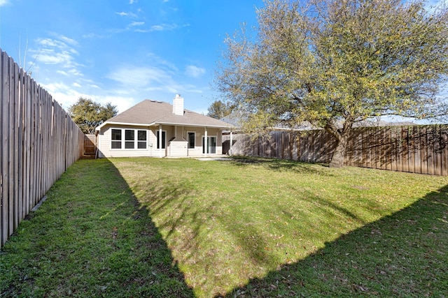 view of yard with a fenced backyard