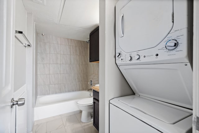 full bathroom featuring vanity, shower / bathtub combination, toilet, and stacked washer and clothes dryer