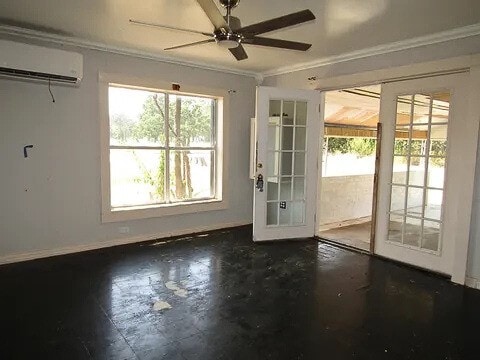 entryway with an AC wall unit, crown molding, french doors, and plenty of natural light