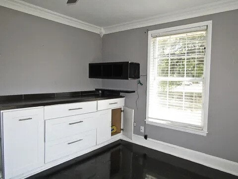 kitchen featuring white cabinets and crown molding