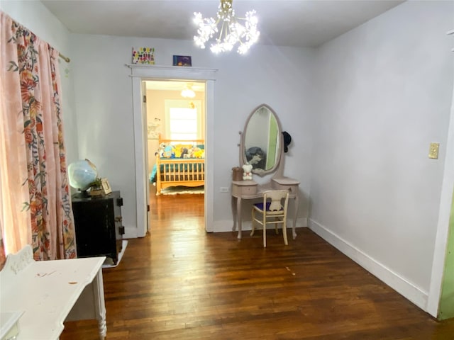 hall featuring a chandelier and dark hardwood / wood-style floors