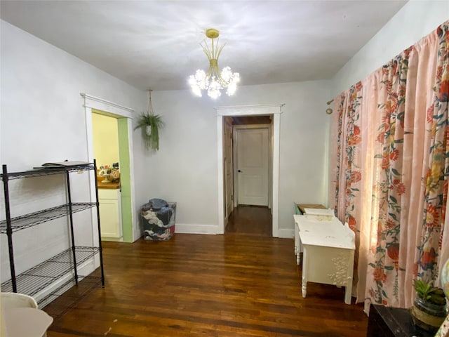 hall featuring dark hardwood / wood-style floors and an inviting chandelier