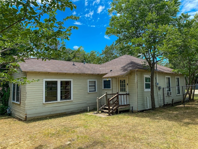 back of property featuring a lawn