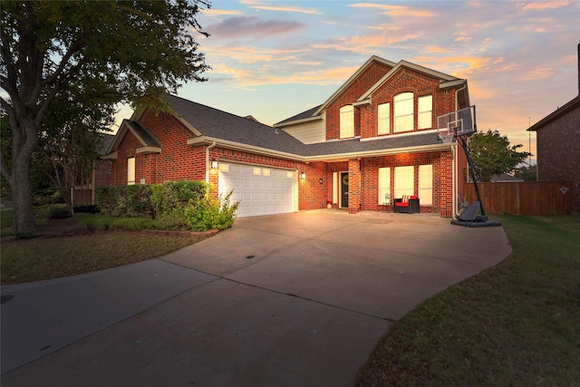 front of property featuring a garage and a lawn