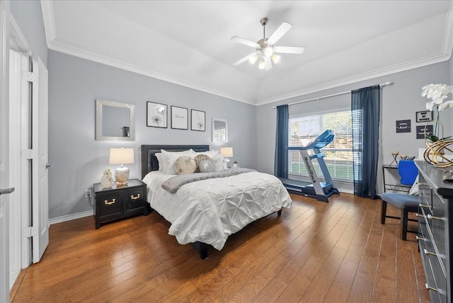 bedroom featuring ceiling fan, dark hardwood / wood-style flooring, and crown molding