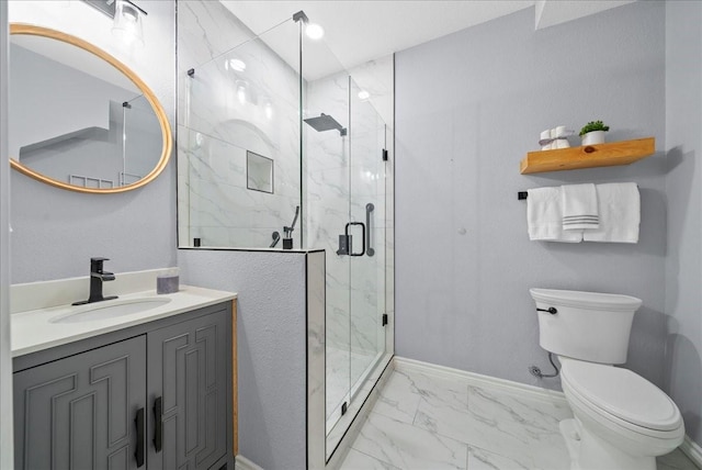 bathroom featuring vanity, toilet, and a shower with shower door