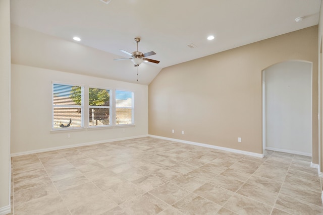 unfurnished room featuring ceiling fan, a healthy amount of sunlight, and vaulted ceiling