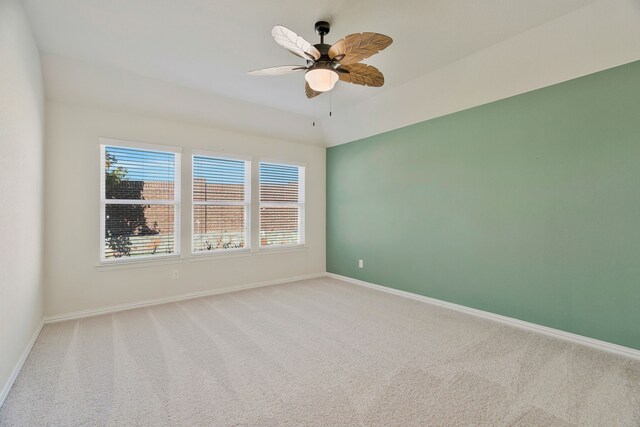 unfurnished bedroom with ceiling fan, light colored carpet, and vaulted ceiling